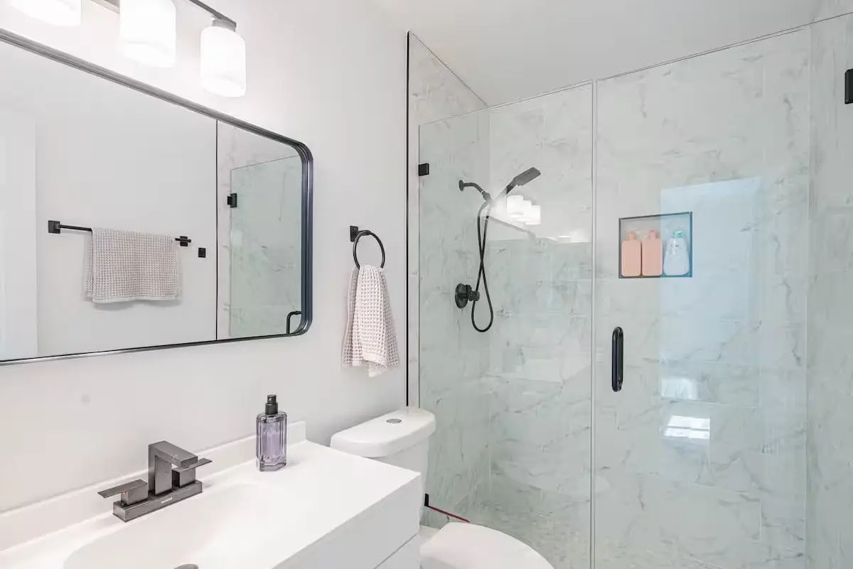 Second bathroom after a turnover: streak-free glass shower, polished fixtures, fresh waffle towels hung